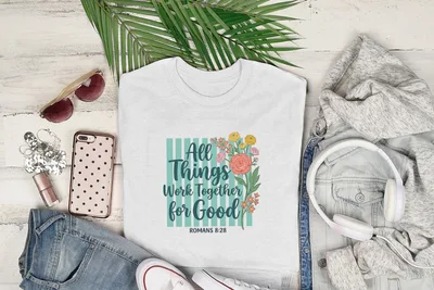 White t-shirt with "All Things Work For Good Romans 8:28" floral design.
