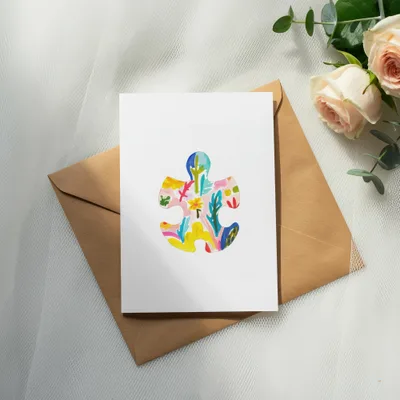 Card with colorful abstract puzzle piece design on kraft envelope.
