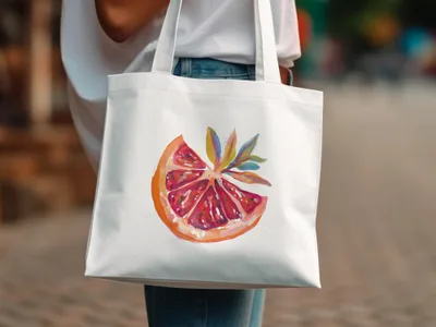 White canvas tote bag with a painted slice of grapefruit and leaves.