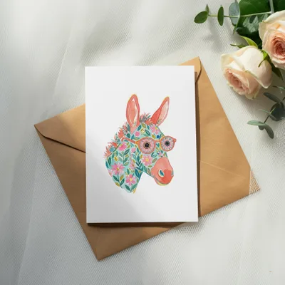 Watercolor donkey with floral pattern and glasses on a card.
