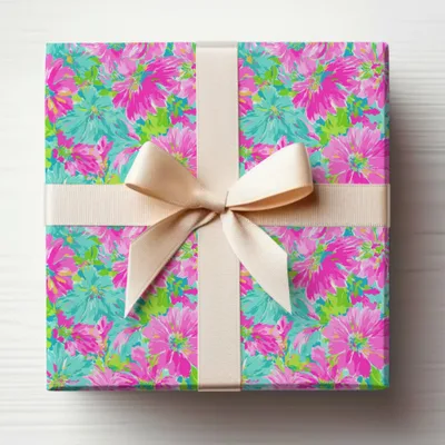 Gift-wrapped box with floral pattern and beige ribbon tied in a bow.