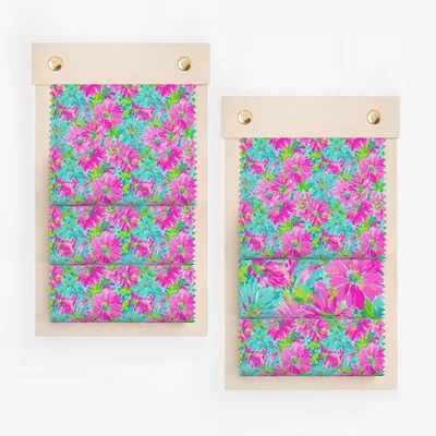 Fabric swatches with floral pattern on wooden hanger.