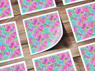Floral patterned cards on a wooden surface, one corner peeling.