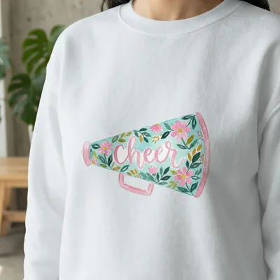 White sweatshirt with a watercolor megaphone design saying "cheer".