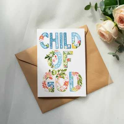 Child of God card with floral lettering on an envelope with roses.