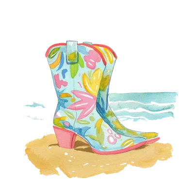 Light blue cowboy boot with floral pattern on sandy beach with ocean waves.