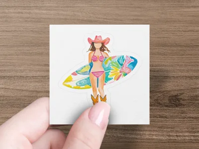 Woman in cowboy hat and bikini holds a surfboard, standing in cowboy boots.