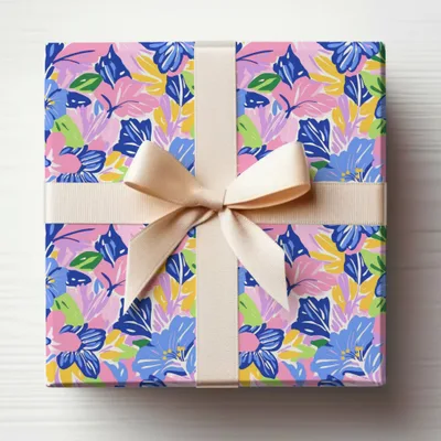 Gift box with a floral pattern, tied with a cream ribbon.