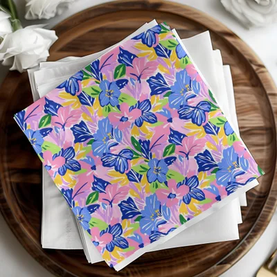 Colorful floral napkins on a wooden tray with white flowers.