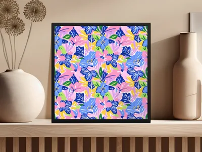 Framed artwork with colorful abstract floral pattern on wooden shelf.
