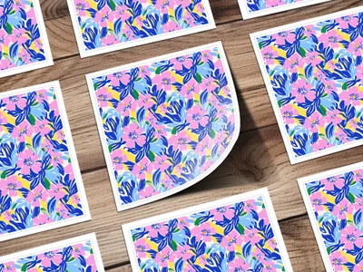 Floral pattern stickers with blue, pink, and yellow flowers on a wooden background.