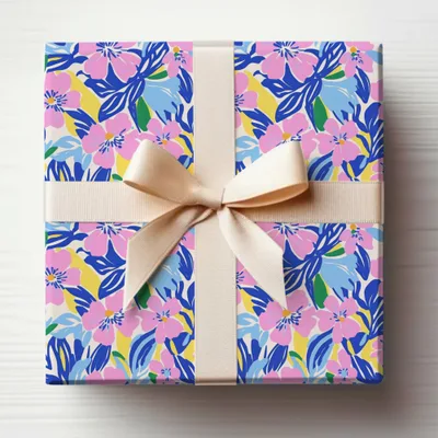 Gift box with a floral pattern and a light beige ribbon.