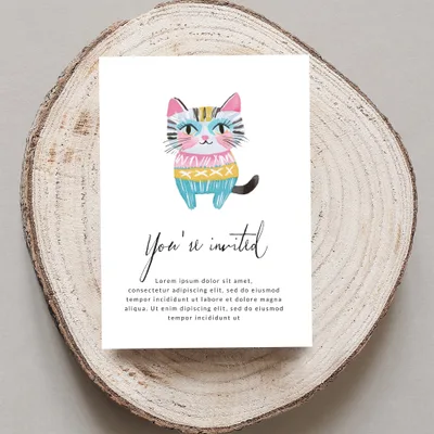 Invitation card with a colorful cartoon cat and "You're invited" text.