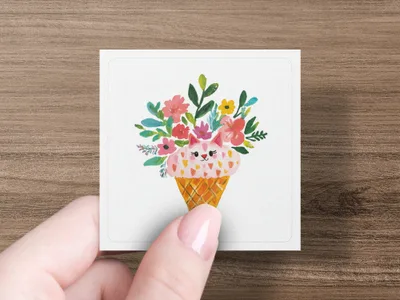 Pink ice cream cone shaped like a cat's face with floral bouquet.