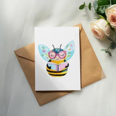 Bee character with glasses reading a book on an envelope with roses.