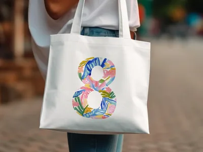 White tote bag with a colorful abstract number 8 design.