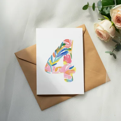 Card with colorful "4" design on brown envelope with roses.