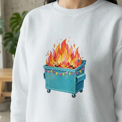 White sweatshirt with a dumpster fire graphic adorned with a festive banner.