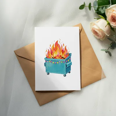 Burning dumpster with colorful flags on a card, with roses and greenery.