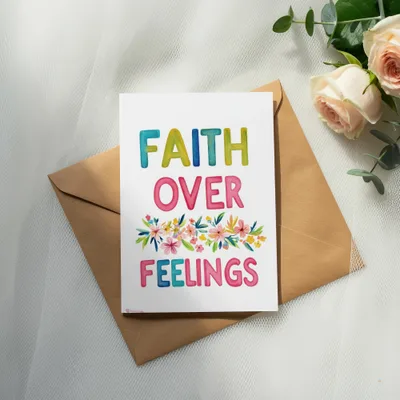 Greeting card with "FAITH OVER FEELINGS" text and floral watercolor design.