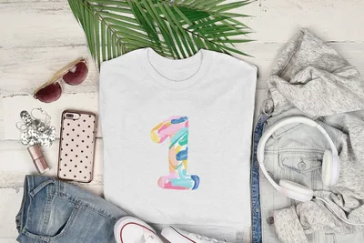 White t-shirt with colorful "1" graphic, sunglasses, phone, and headphones.