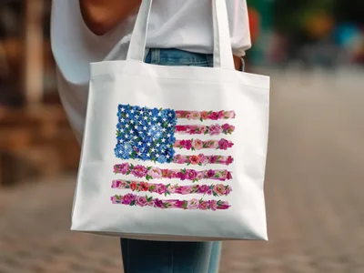 White tote bag with an American flag design made of flowers.