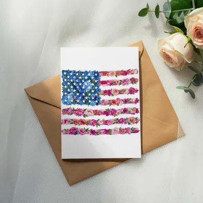 Card with floral American flag design on brown envelope, roses, and eucalyptus.