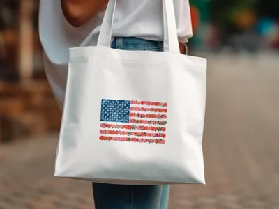 White canvas tote bag with a floral American flag design.