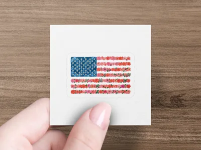 American flag made of red, pink, and white flowers on a white background.