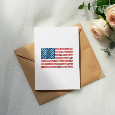 American flag made of floral illustrations on a white card.