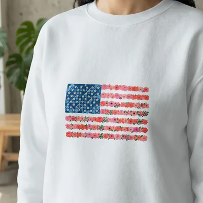 White sweatshirt with an American flag design made of flowers.
