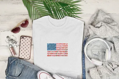 White t-shirt with American flag design made of colorful flowers.
