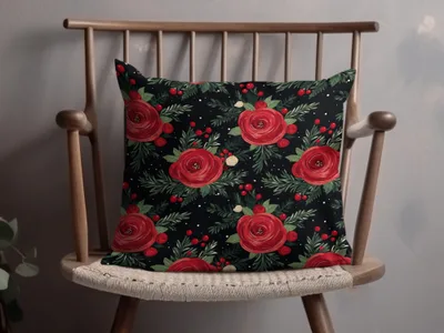Floral Arrangement on Black Background Artful Design pillow with red roses and green leaves on a wooden chair.