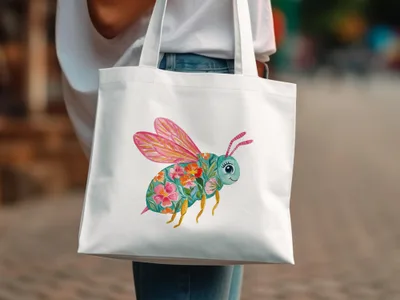 White tote bag with a colorful bee illustration, featuring floral wings.