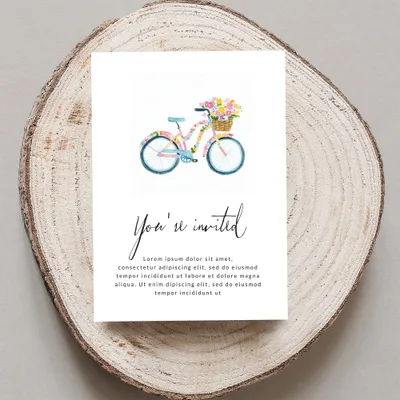 Watercolor bicycle with flowers in basket on "You're invited" card.