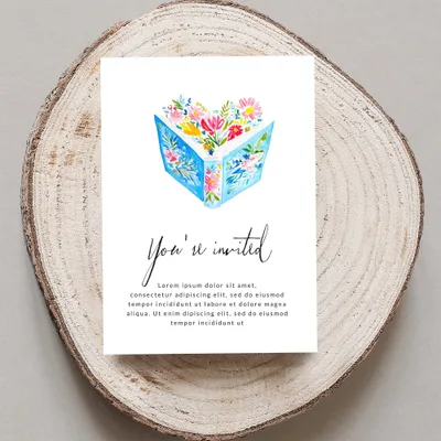 Invitation with watercolor open book, flowers, and "You're invited" text.