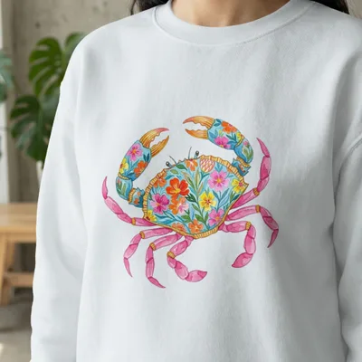 White sweatshirt with a colorful floral crab graphic.