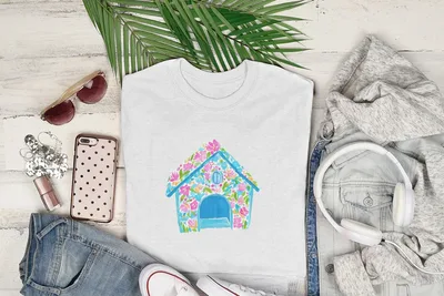 White t-shirt with a blue doghouse design in floral watercolor.
