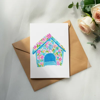 Watercolor dog house illustration on card with pink roses and eucalyptus.