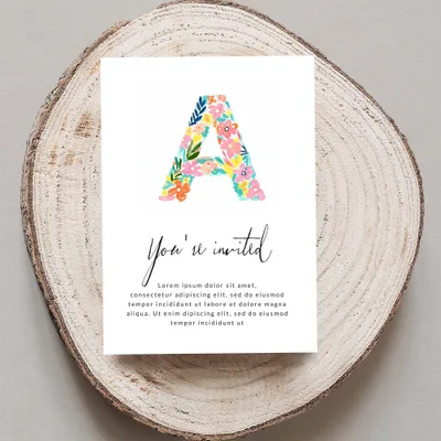 Invitation card with floral letter A and placeholder text.