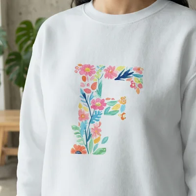 White sweatshirt with a floral letter "F" design.