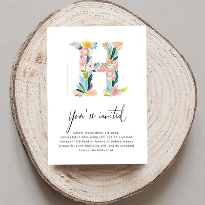 Floral letter "H" on invitation with "You're invited" and placeholder text.