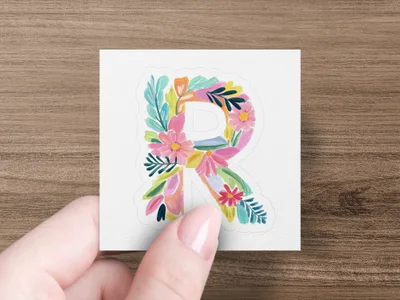 Letter R decorated with colorful flowers and leaves.
