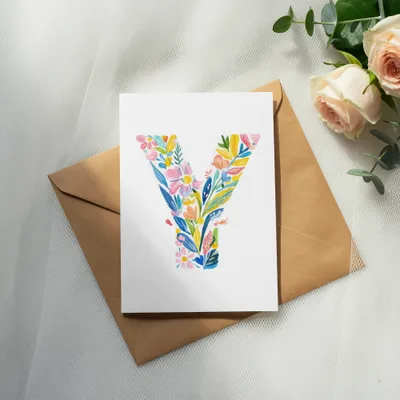 Watercolor letter Y with colorful flowers and leaves on card with envelope.