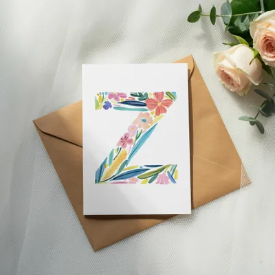 Card with colorful floral letter Z on a brown envelope, with roses.
