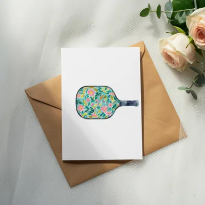 White card on brown envelope with pickleball paddle design.