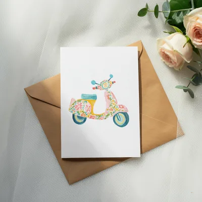 Watercolor illustration of a colorful floral scooter on a greeting card.