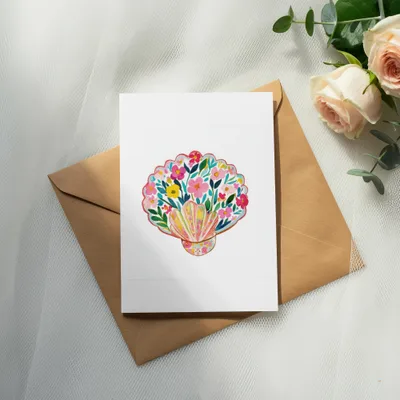 Card with watercolor seashell illustration, featuring colorful flowers and foliage.