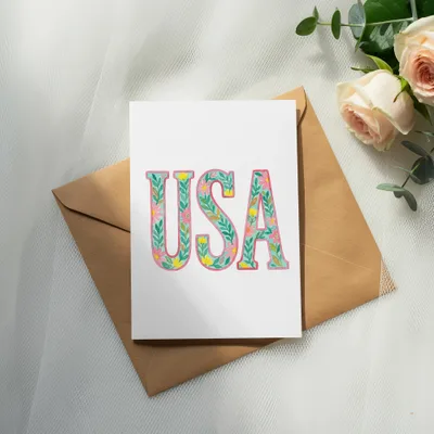Card with "USA" in floral lettering on an envelope with roses.