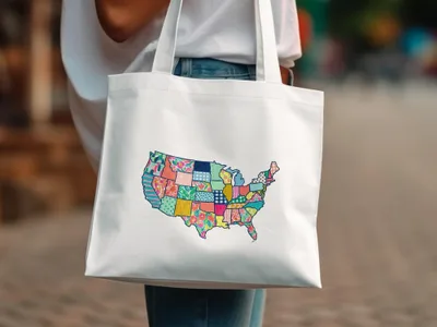 White tote bag with a colorful patchwork map of the United States.